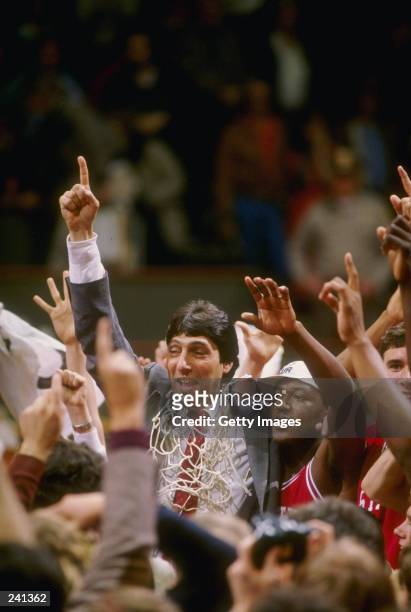 Head coach Jim Valvano of the North Carolina State Wolfpack celebrates with his team after the Wolfpack defeated the Houston Cougars 54-52 in the...
