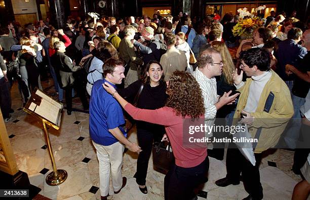 Hundreds of people each pretend to greet a long lost friend as they participate in a "flash mob" in the lobby of the Westin St. Francis Hotel August...