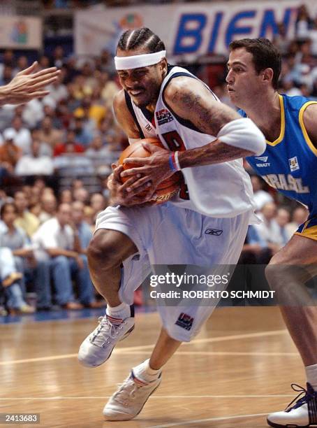 Allen Iverson of the USA is fouled as he drives to the basket in his team's first round game against Brazil at the Roberto Clemente Coliseum in San...