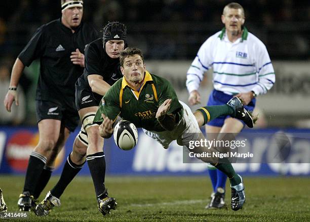 Joost van der Westhuizen of the Springboks throws out a long pass during the Tri-Nations test match between the New Zealand All Blacks and South...