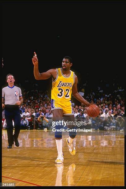 Point guard Magic Johnson of the Los Angeles Lakers dribbles the ball down the court during a game at the Great Western Forum in Inglewood,...