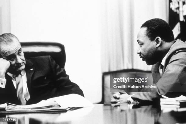 President Lyndon B Johnson discusses the Voting Rights Act with civil rights campaigner Martin Luther King Jr . The act, part of President Johnson's...