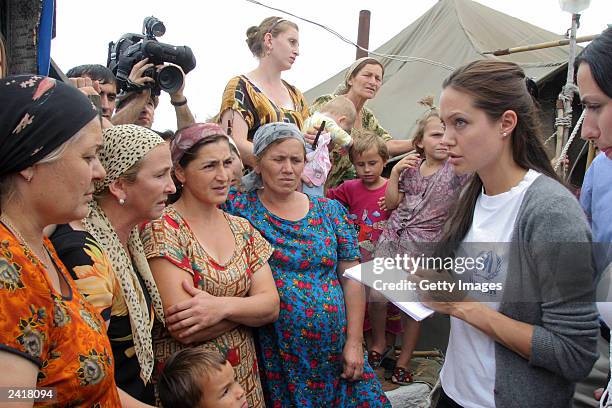 Actress Angelina Jolie talks with Chechen refugees in Bella refugee camp during her visit August 22, 2003 in Ingushetia, near the Chechen border in...