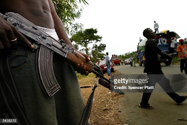 Member of the main rebel group Liberians United for Reconciliation and Democracy guards a bridge August 22, 2003 in Po River, Liberia. After a month...