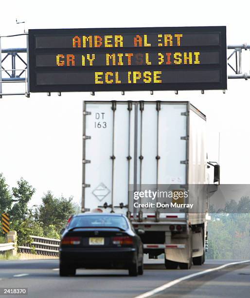 Truck passes under an Amber Alert sign on Interstate 295 August 22, 2003 in Princeton, New Jersey. An Amber Alert was issued for a four-year-old boy...