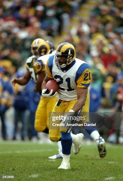 Running back Lawrence Phillips of the St. Louis Rams runs with the ball during a game against the Green Bay Packers at Lambeau Field in Green Bay,...