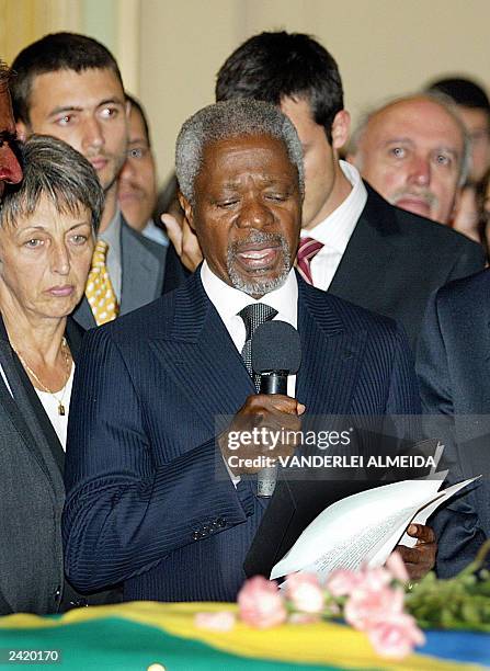 Secretary General Kofi Annan gives a speech as Brazilian born UN diplomat Sergio Vieira de Mello's widow Annie listens during a remembrance ceremony...