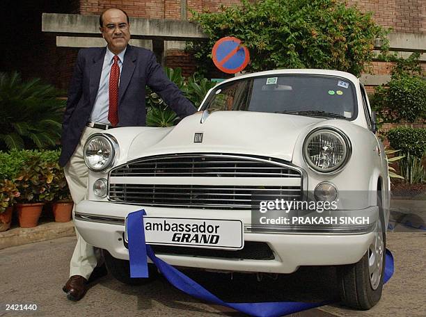 Marketing Vice President of Hindustan Motors Satish Burman poses with the new Ambassador 'Grand' motorcar during its launch in New Delhi, 18 August...