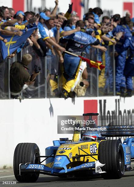 Fernando Alonso of Spain and Renault celebrates as he crosses the line to win the Formula One Hungarian Grand Prix at the Hungaroring on August 24,...