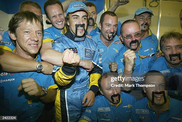 Fernando Alonso of Spain and Renault celebrates with the Renault team after winning the Formula One Hungarian Grand Prix at the Hungaroring on August...