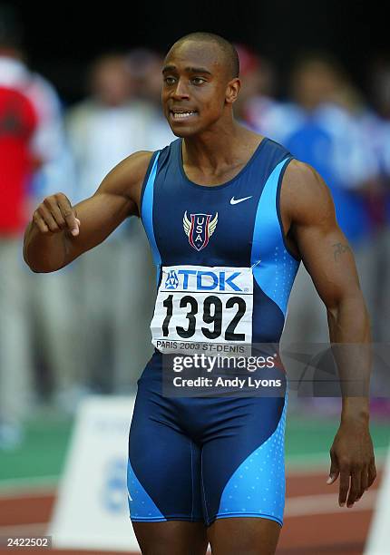 Jon Drummond of USA protests his innocence to a false start during the men's 100m quarter final at the 9th IAAF World Athletics Championship August...