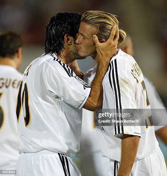 David Beckham of Real Madrid celebrates with team-mate Luis Figo after Figo scored the first goal during the Spanish Super Cup Ist leg match between...