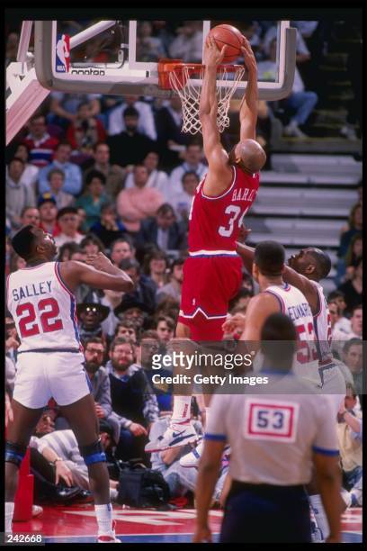 Forward Charles Barkley of the Philadelphia 76ers slam dunks during a game against the Detroit Pistons at The Palace of Auburn Hills in Auburn Hill,...