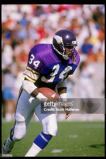 Running back Herschel Walker of the Minnesota Vikings runs with the ball during a game against the Tampa Bay Buccaneers at Tampa Stadium in Tampa,...