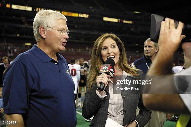 Sideline reporter Lisa Guerrero interviews head coach Mike Martz of the St. Louis Rams following their victory over the Tampa Bay Buccaneers in the...