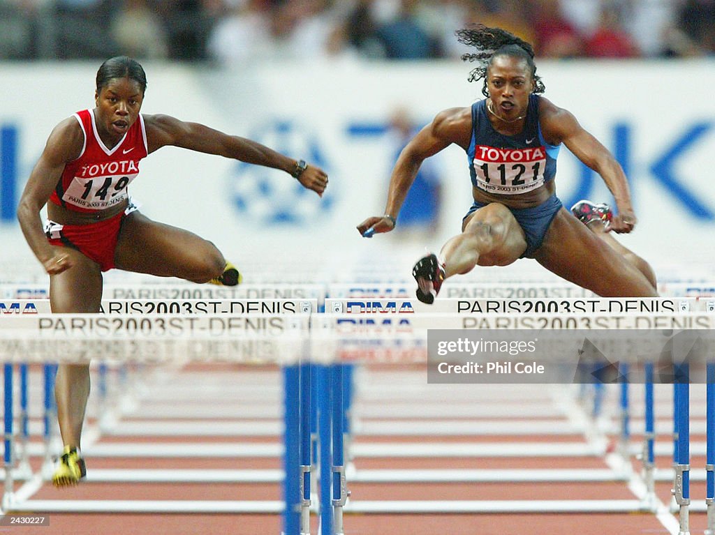 Perdita Felicien of Canada (L) in action next to Gail Devers of USA during the women's 100 meter hurdles semi-final 