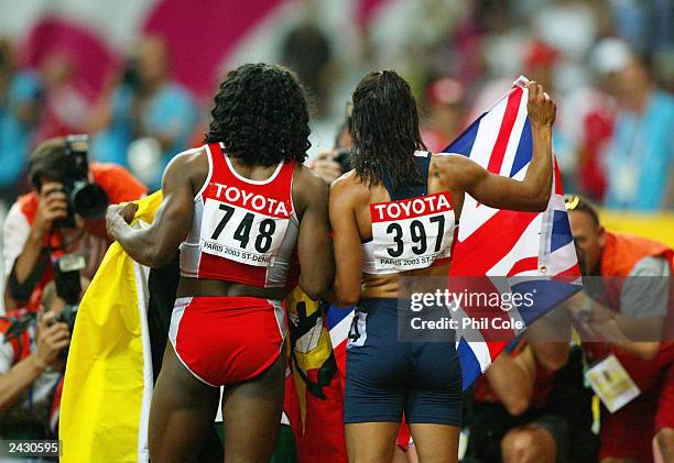 Kelly Holms of Great Britain and Maria Mutola of Mozambique pose for a picture after the women's 800m final at the 9th IAAF World Athletics...