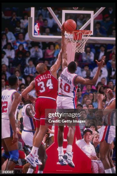 Forward Dennis Rodman of the Detroit Pistons battles for the ball with forward Charles Barkley of the Philadelphia 76ers during a game at The Palace...