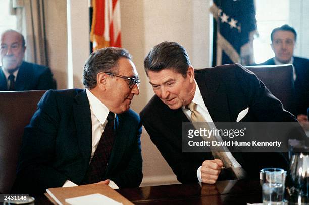 President Ronald Reagan and former Secretary of State Dr. Henry Kissinger whisper during a meeting in 1983 in Washington, DC. Secretary of State...