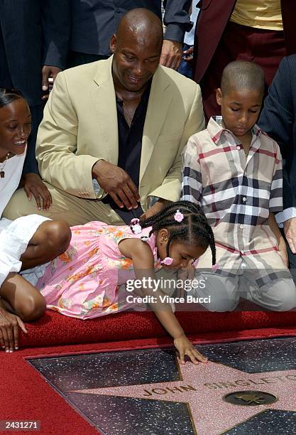 Director John Singleton and relatives attend a ceremony honoring him with a star on the Hollywood Walk of Fame in front of Mann's Chinese Theatre...