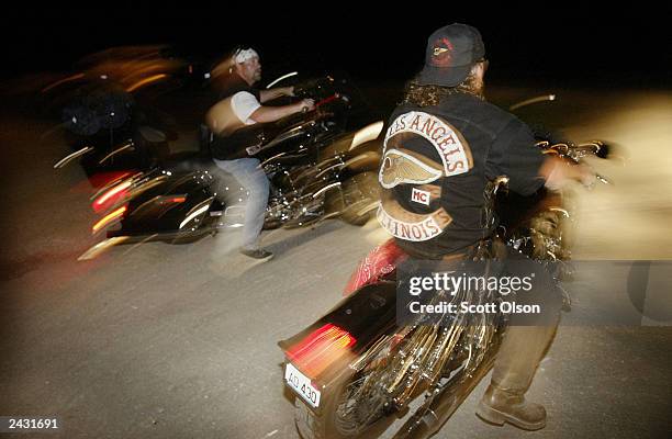 Hells Angels Storman and Tim leave a party on their Harley-Davidson motorcycles June 28, 2003 in Millstadt, Illinois. The party, outside this small...
