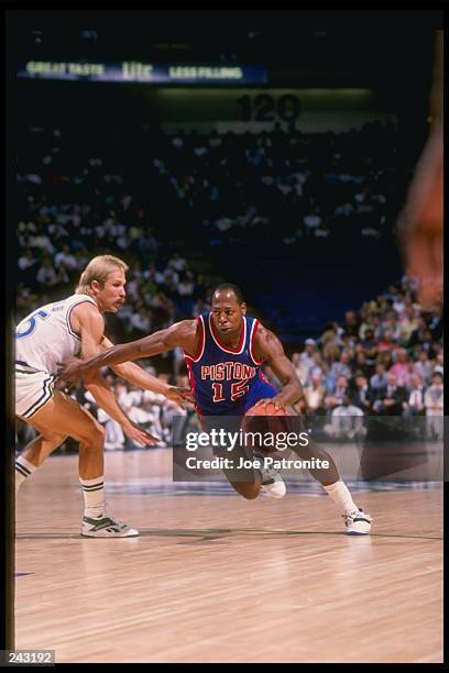 Guard Vinnie Johnson of the Detroit Pistons drives the ball past guard Brad Davis of the Dallas Mavericks during a game at Reunion Arena in Dallas,...