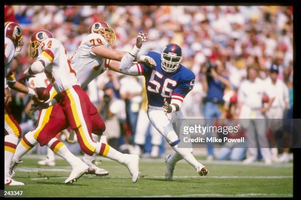 Linebacker Lawrence Taylor of the New York Giants in action during a game against the Washington Redskins at Robert F. Kennedy Memorial Stadium in...