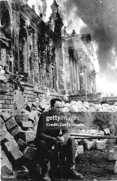 German soldier sits on the ruins of the Reichstag on May 9 Berlin, Germany in this photo taken by Russian photographer Mark Redkin. On May 8, 2000...