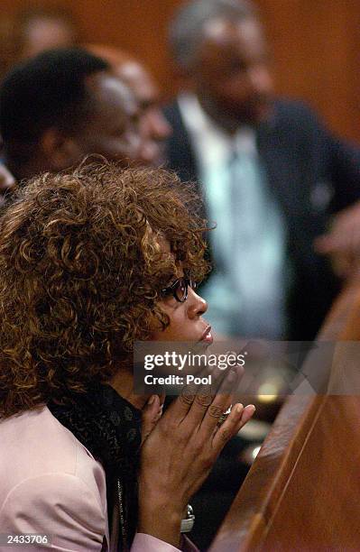 Singer Whitney Houston listens at a probation violation hearing for her husband, singer Bobby Brown at the DeKalb County Courthouse August 27, 2003...