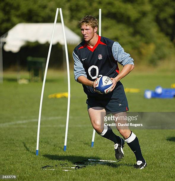 Ollie Smith the England centre moves forward with the ball during England Rugby Union training held at the Domain de Tournon Hotel on August 27, 2003...