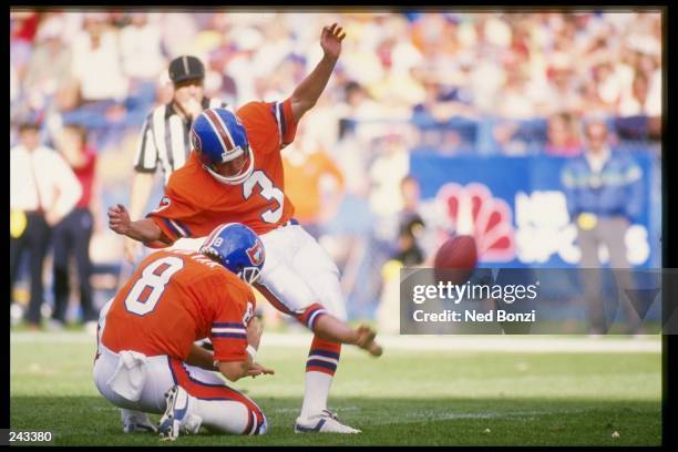 Kicker Rich Karlis of the Denver Broncos kicks the ball during a game against the New England Patriots at Mile High Stadium in Denver, Colorado. The...