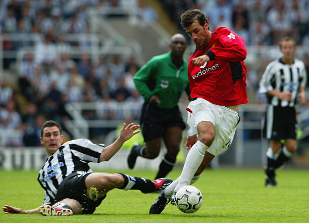 Ruud van Nistelrooy of Manchester United takes the ball past Andy Griffin of Newcastle United during the FA Barclaycard Premiership match held on...
