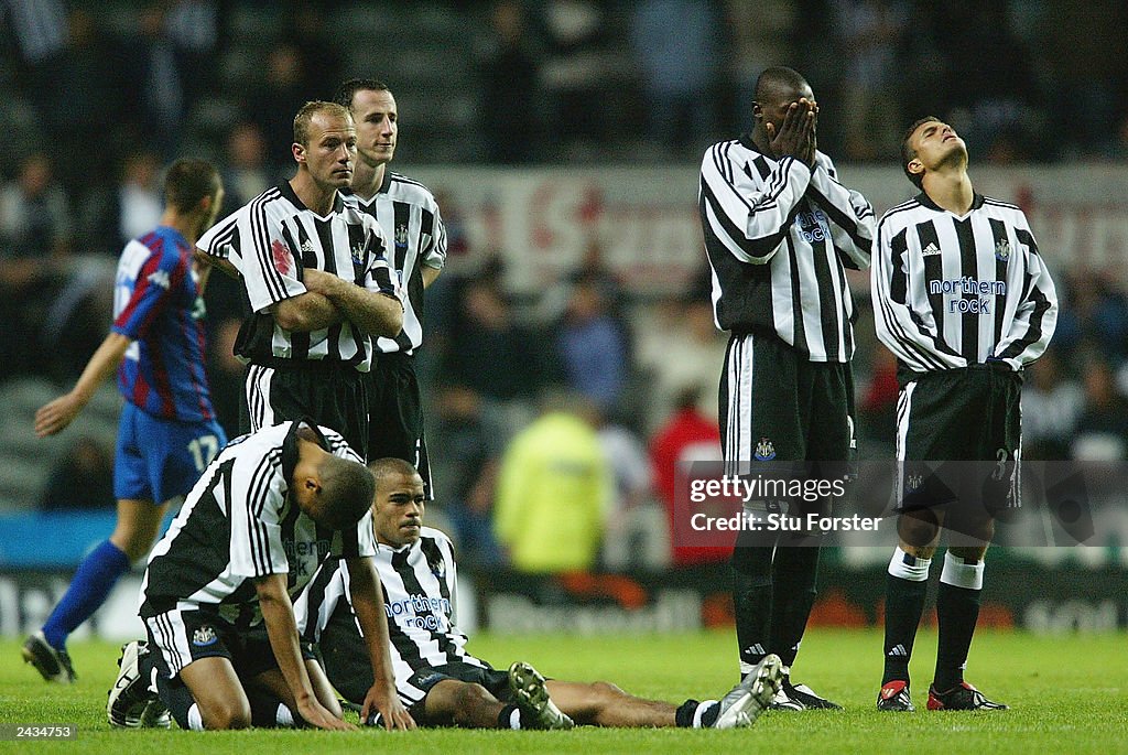 Newcastle players look dejected after Aaron Hughes misses his penalty