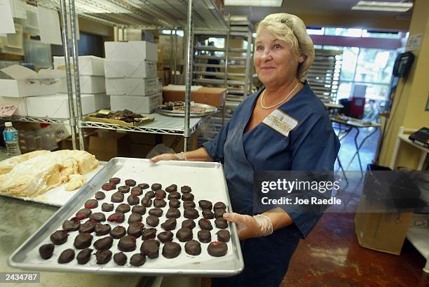 Renata Klintsevich carries a tray of dark chocolate covered strawberries August 27, 2003 at Le Chocolatier in North Miami Beach, Florida. A recent...
