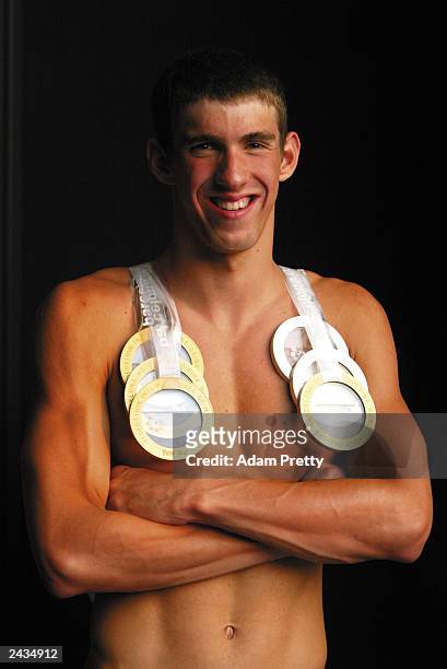 Michael Phelps of the USA smiles as he wears his six medals won during the 10th Fina World Swimming Championships 2003 at Palau Sant Jordi July 27,...
