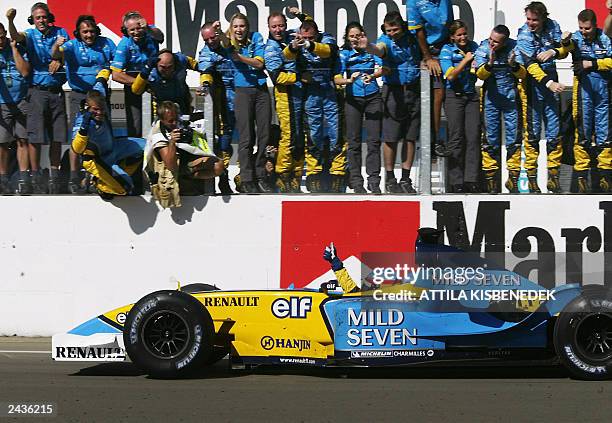 Spanish Renault driver Fernando Alonso jubilates as he crosses the finish line of the Hungaroring racetrack near Budapest, 24 August 2003, after the...