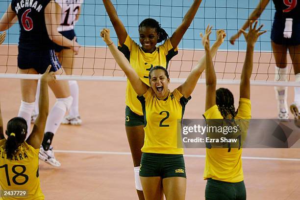 Danielle Lins, Fablana Claudino, and Joyce Solva of Brazil celebrate after winning a point against the USA during their game at Centro Olimpico Juan...