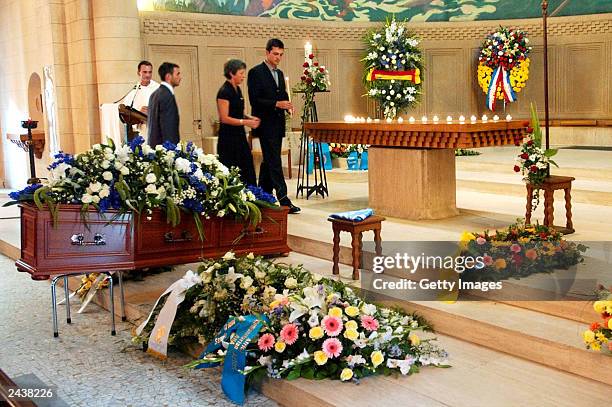 Special envoy to Iraq, Sergio Vieira de Mello's sons, Laurent and Adrian de Mello and his wife Annie light a candle during his funeral at Saint...