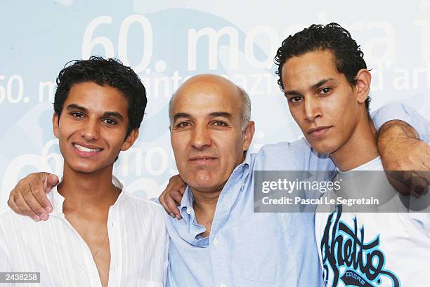 Director Abdelkrim Bahloul poses with actors Mehdi Dehbi and Ouassini Embarek during a photocall for "Le Soleil Assassine" at the 60th Venice Film...