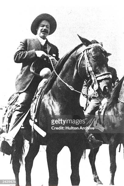 Mexican revolutionary Pancho Villa smiles while sitting on horseback, c. 1911.