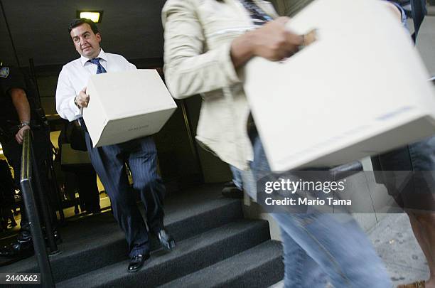 Reporters carry out boxes of transcripts of emergency calls made at the World Trade Center on September 11 released by the Port Authority of New York...