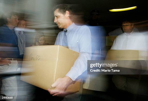 Reporters carry out boxes of transcripts of emergency calls made at the World Trade Center on September 11 released by the Port Authority of New York...