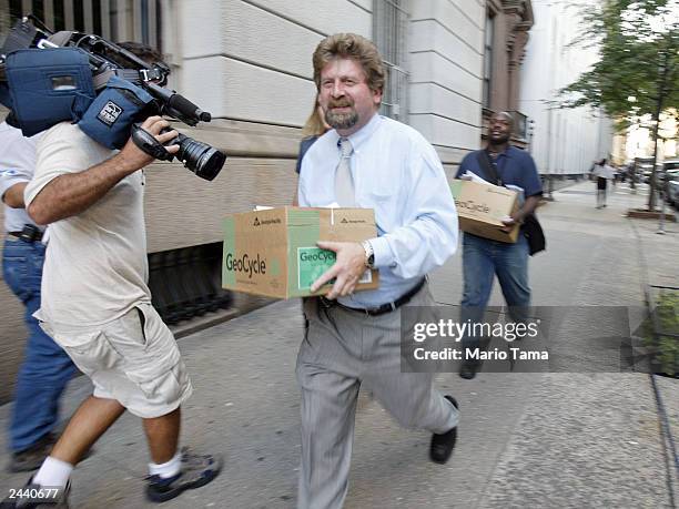 Reporters carry out boxes of transcripts of emergency calls made at the World Trade Center on September 11 released by the Port Authority of New York...