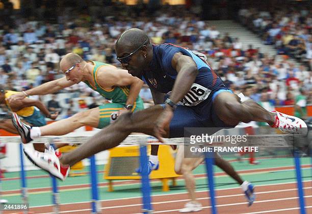 Allen Johnson clears a hurdle to win heat two of the men's 110m hurdles first round, ahead of South African Shaun Bownes 28 August 2003, during the...