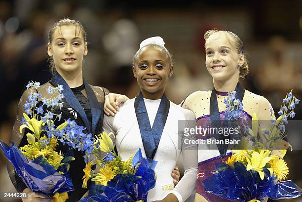 Catalina Ponor of Romania wins the silver medal, Daiane Dos Santos of Brazil wins the gold medal and Elena Gomez of Spain wins the bronze medal in...