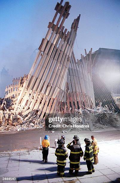 New York City firefighters look at the detroyed facade of the World Trade Center September 13, 2001 two days after the twin towers were destroyed...