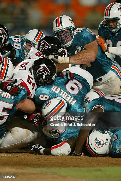 Quarterback Jay Fiedler of the Miami Dolphins keeps the ball for a first down against the Atlanta Falcons during the NFL preseason game at Pro Player...