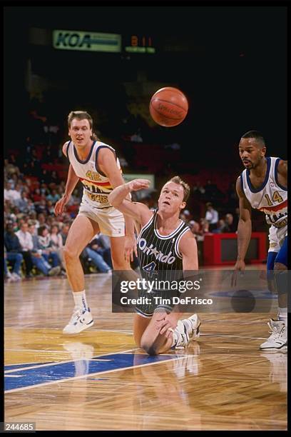 Guard Scott Skiles of the Orlando Magic dives for the ball during a game against the Denver Nuggets at the McNichols Sports Arena in Denver,...