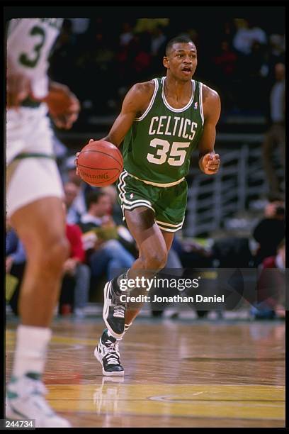Guard Reggie Lewis of the Boston Celtics dribbles the ball down the court during a game against the Milwaukee Bucks at the Bradley Center in...