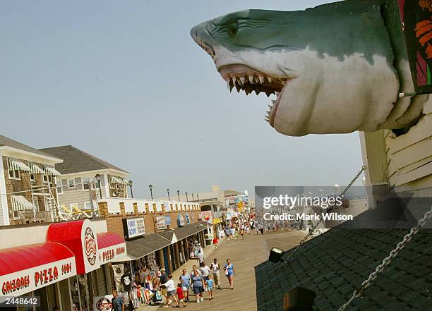 Shark model hangs from a building over top the boardwalk August 30, 2003 in Ocean City, Maryland. The Labor Day weekend marks the unofficial end of...